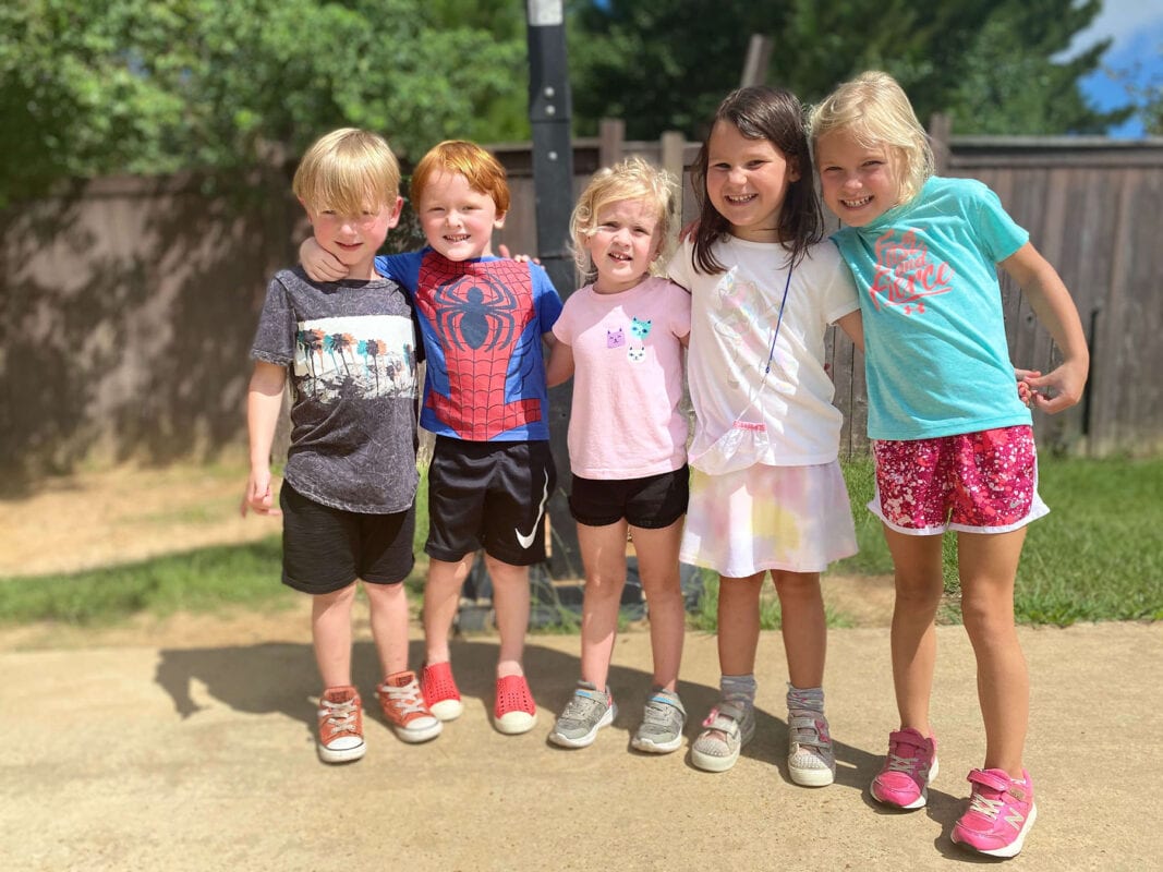 5 kids outside smiling at the camera