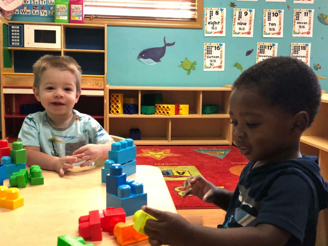 Children playing with blocks at a table